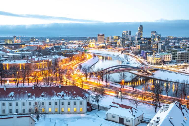 Vilnius, capital of Lithuania, beautiful scenic aerial panorama of modern business financial district architecture buildings with river and bridge in winter, Global City of the Future